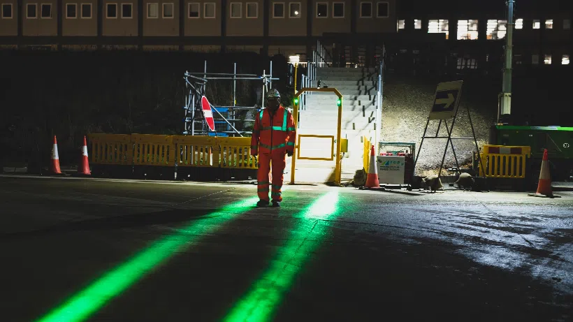 man crossing a smart illuminated safety walkway in low light conditions