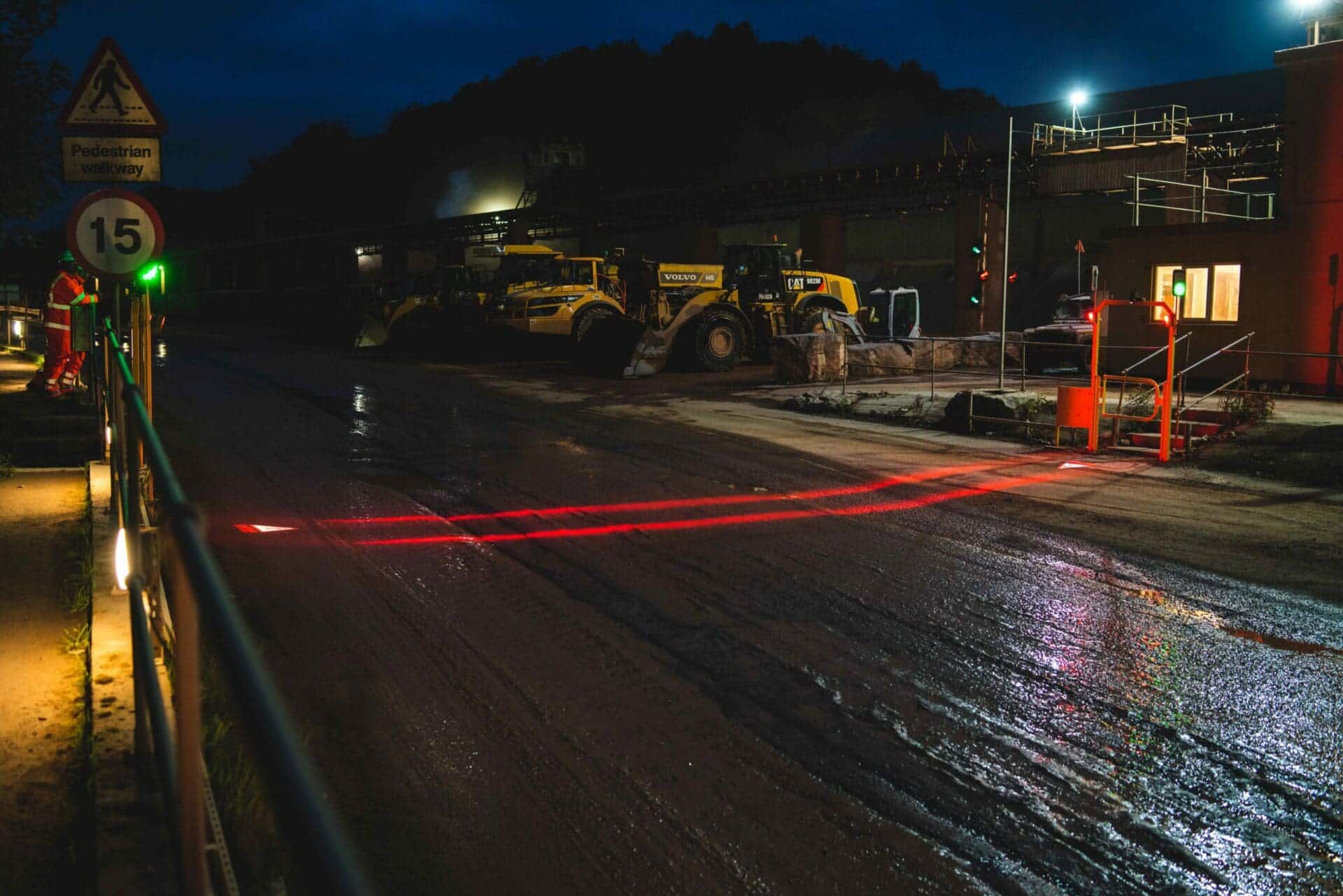 illuminated safety walkway segregating pedestrians and vehicles at night